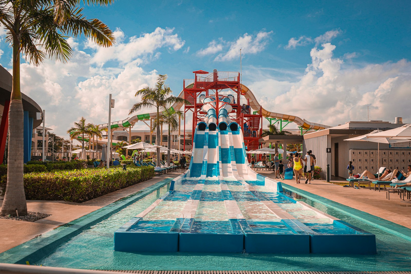 Tropical water park with body slides and lounge chairs, similar to Adventure Island in Tampa